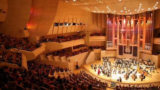 concert hall with orchestra playing